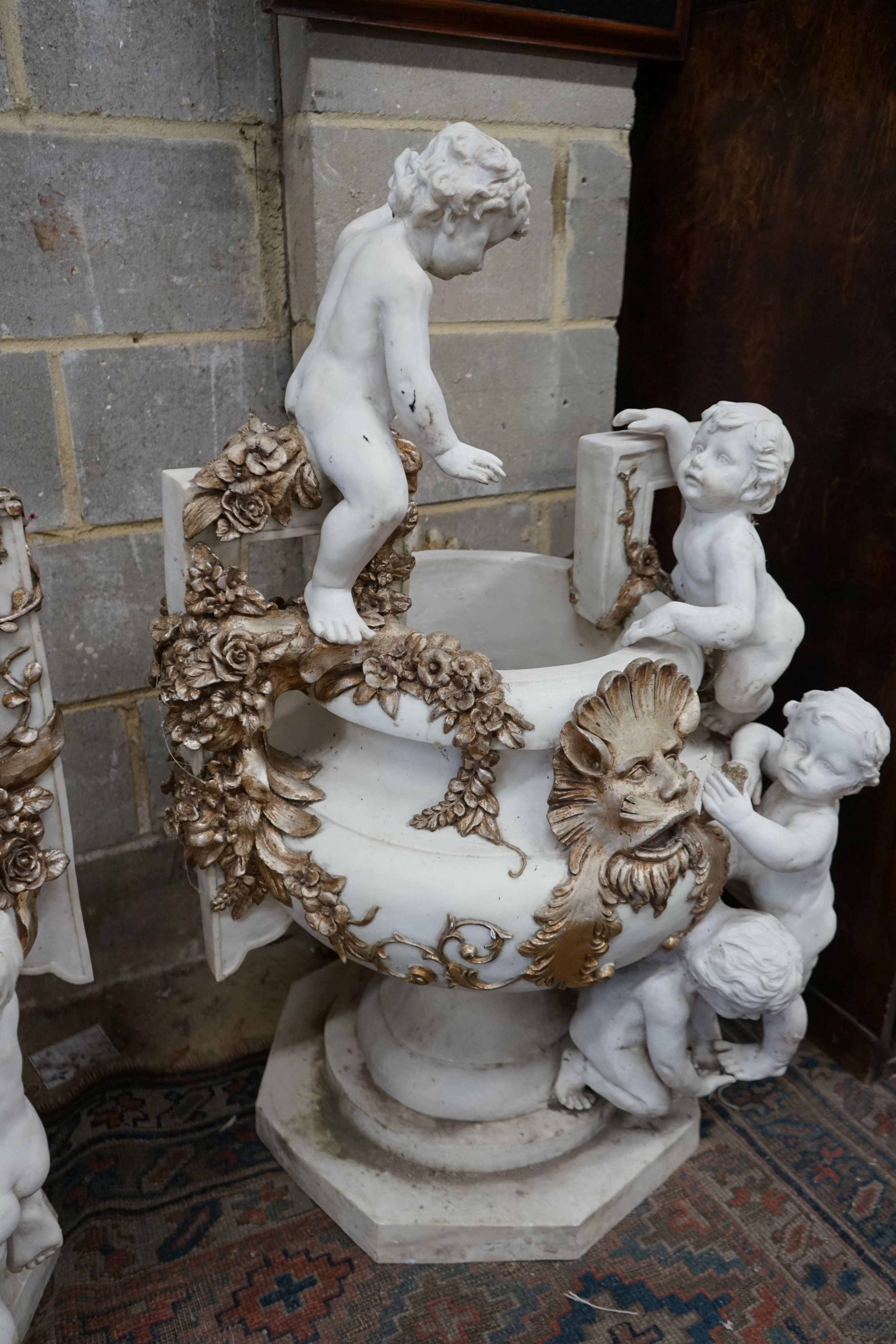 A pair of composition faux marble cherub and mask jardinieres, height 112cm